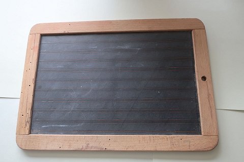 An old blackboard/slate mad of slate with an edge of wood