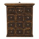 A black decorated wall-mounted cabient with 12 drawers. Denmark circa 1860-80. H: 61cm. W: 54cm. D: 29cm