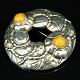 Georg Jensen; A brooch of sterling silver set with amber #42, anniversary brooch 1904 - 1994