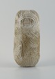 Christina Muff, dansk samtidskeramiker (f. 1971).Unique, handcarved vase in stoneware clay. Covered in a shiny, semi transparent glaze with white flakes.