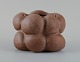 Christina Muff, dansk samtidskeramiker (f. 1971).Dark brown unglazed vessel. Organic shaped vase with lips. Clear glaze inside.