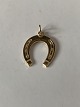 Horse shoe as a pendant/charm in 14 carat gold, stamped 585