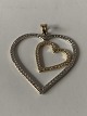 Heart-shaped pendant in 14 carat red and white gold with stone.
