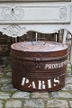 Old oval metal box with old original paint, fine patina and writing on the side 
"Paris"...