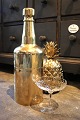 Old champagne cooler in the shape of a large bottle in brass that can be opened 
and filled with ice cubes...