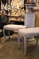 Old rococo stool in wood with a fine gray patinated color and seat upholstered in linen...