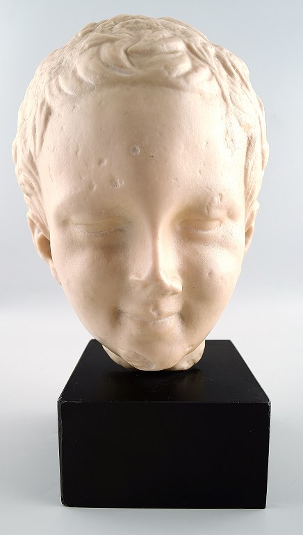 Boys bust in alabaster on plinth.