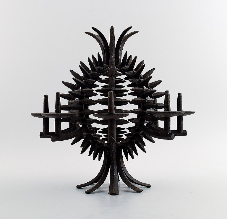 Jens H. Quistgaard: b. Copenhagen 1919, d. 2008.A circular, pineapple shaped candlestick of patinated iron. Eight candle holders/spears.