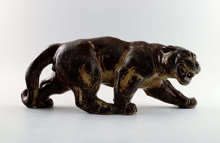 Knud Kyhn: b. Frederiksberg 1880, d. Farum 1969.  A Royal Copenhagen stoneware large figure modelled in the shape of a panther, decorated with sung glaze.