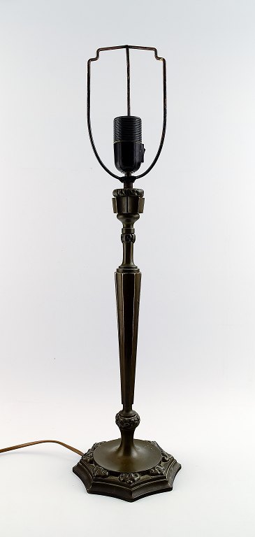 Thorvald Bindesbøll: b. Copenhagen 1846, d. 1908.Table Lamp. Patinated bronze with art nouveau ornamentation in relief on eight-sided foot.