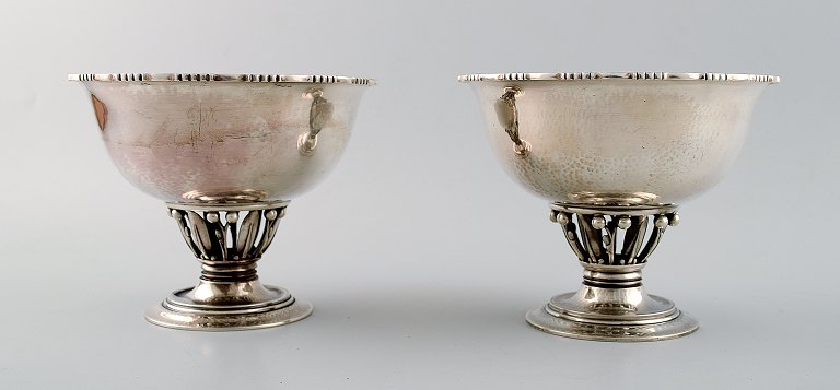 Georg Jensen, b. Rådvad 1866, d. Hellerup 1935.A pair of hammered sterling silver centrepieces.