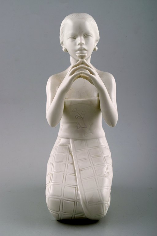 Harald Salomon for Rörstrand, white glazed figure of Balinese holding flower in her hand.