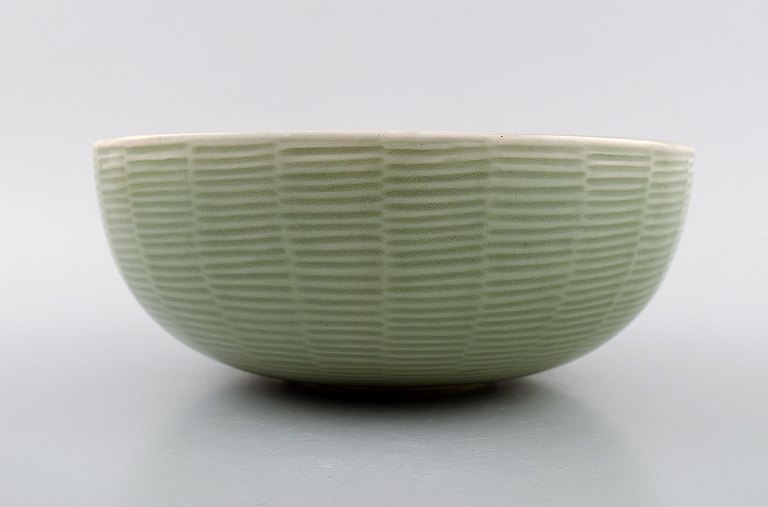Axel Salto: A Royal Copenhagen stoneware bowl decorated with fluted pattern with celadon glaze.