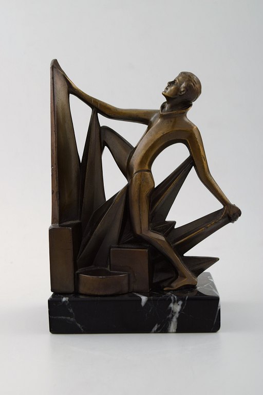 Art deco bookend in bronze on marble base.