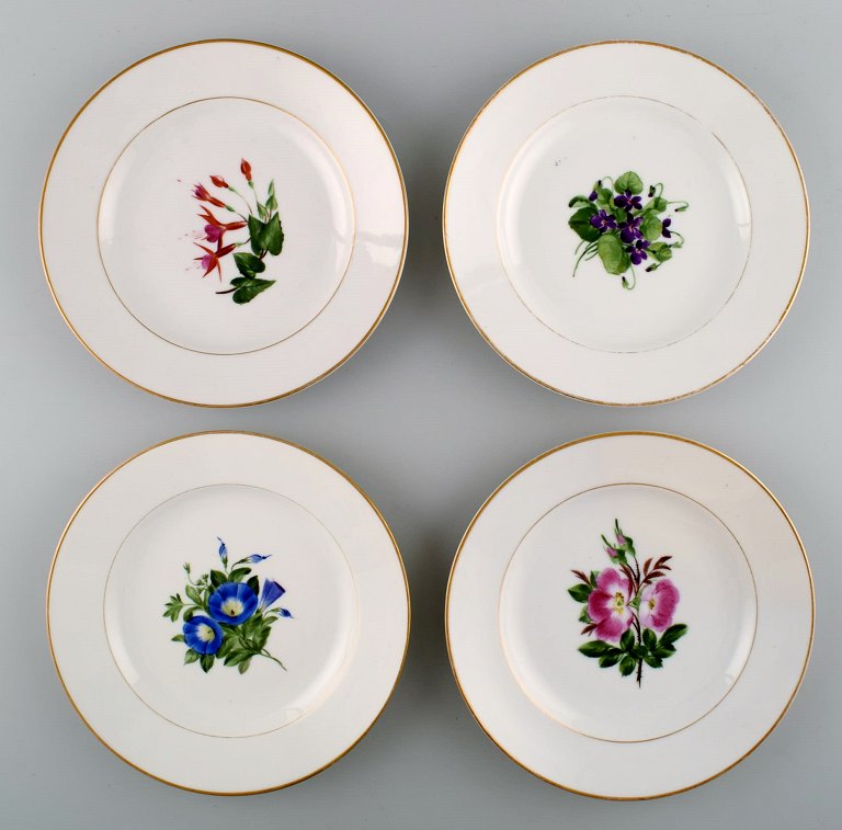 4 antique Royal Copenhagen flat plates in flora danica style.