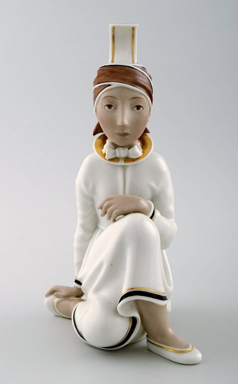 Rare Arno Malinowski for Royal Copenhagen.Seated girl with headwear. Overglaze.