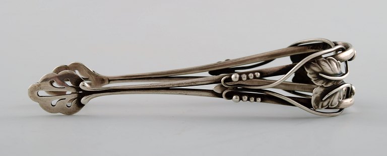 Rare Georg Jensen sugar tongs, richly ornamented.Design 101.