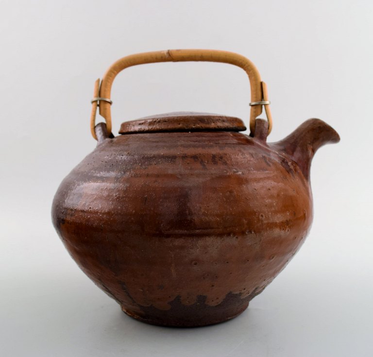 Gutte Eriksen own workshop, tea pot in ceramics. Handle in wicker.Stamped: Gutte.