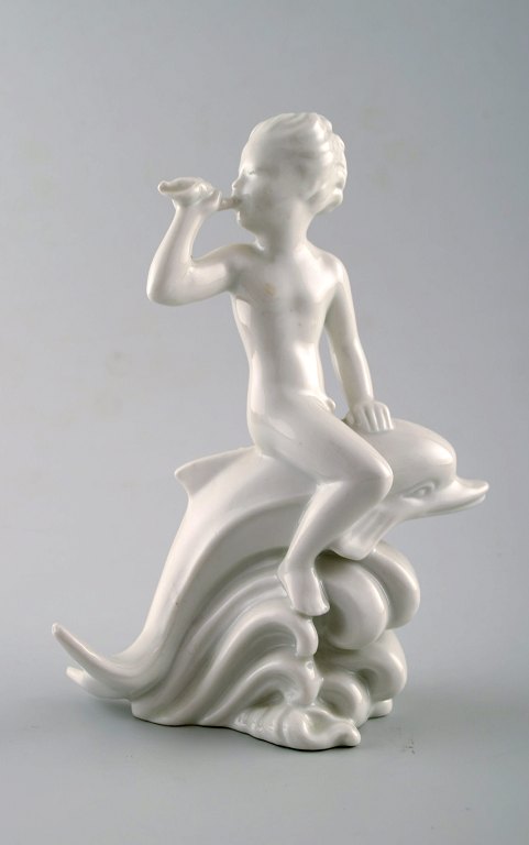 Harald Salomon for Rörstrand, blanc de chine/hvidglaseret figur forestillende faun/panfigur ridende på delfin.