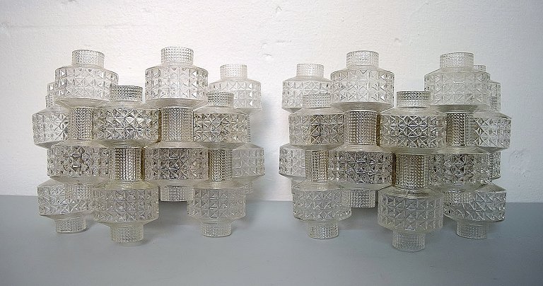 Swedish designer: A pair of wall lamps with glass screens.