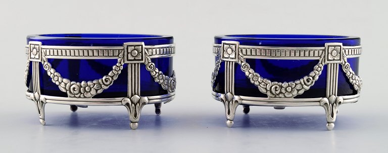 A pair of English salt vessels with glass inserts in English silver.