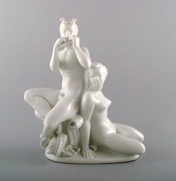 Harald Salomon for Rörstrand, white glazed porcelain Art Deco figure of a naked woman and flute-playing pan.