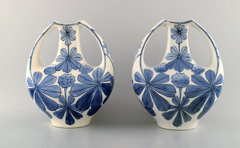 A pair of faience vases, Art Nouveau. Design by Alf Wallander for Rörstrand. Early 1900s. Decorated with flowers.