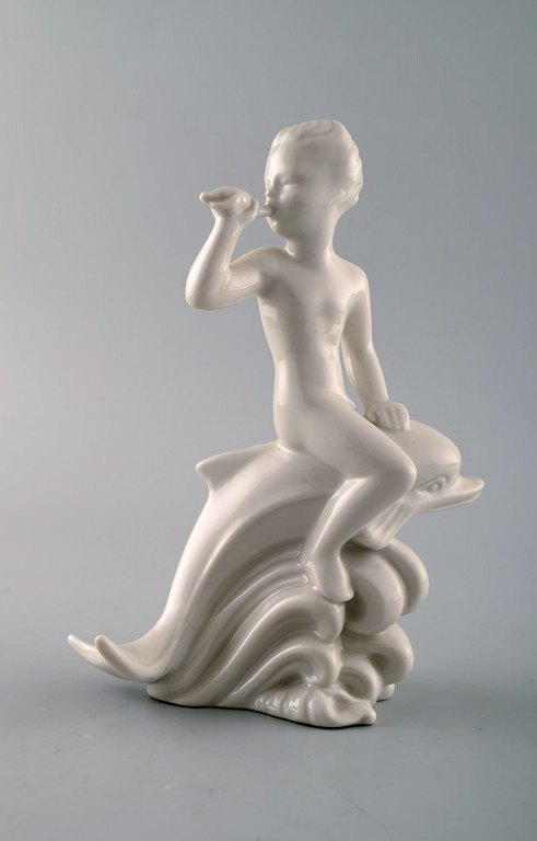 Harald Salomon for Rörstrand, blanc de chine/hvidglaseret figur forestillende faun/panfigur ridende på delfin.