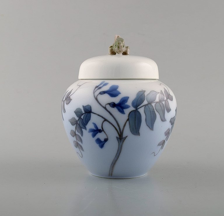 Royal Copenhagen. Porcelain lidded jar with grasshopper and flowers. Ca. 1920.