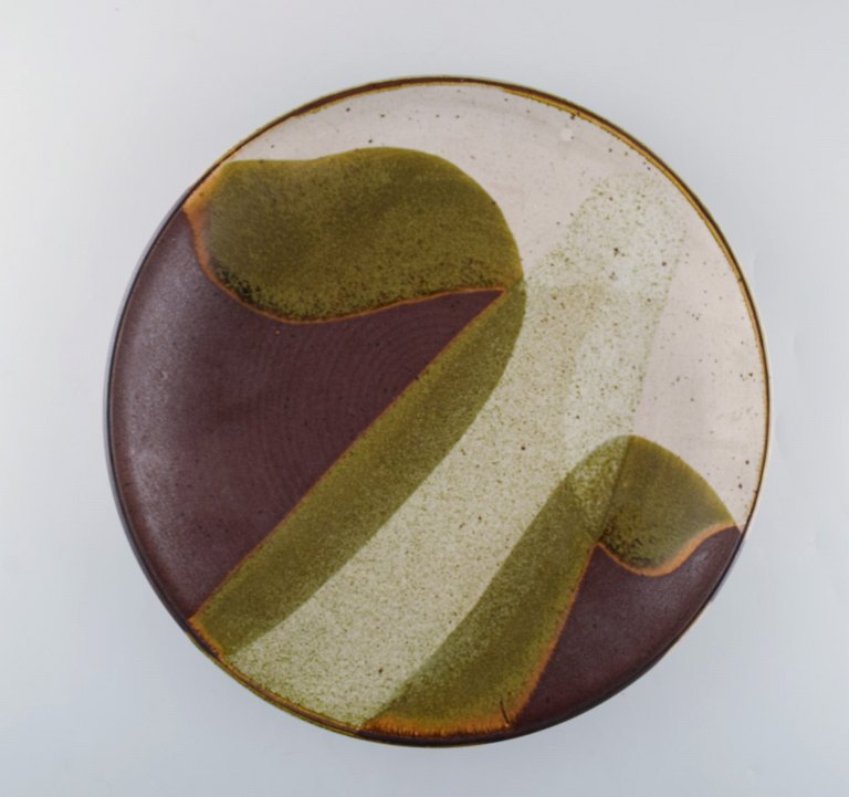 European studio ceramist. Unique dish in glazed ceramics. Dated 1985. Beautiful glaze in gray and olive green tones.