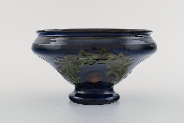 Kähler, Denmark. Bowl in glazed ceramics. Green leaves and red berries on a dark blue background. 1930 / 40s.