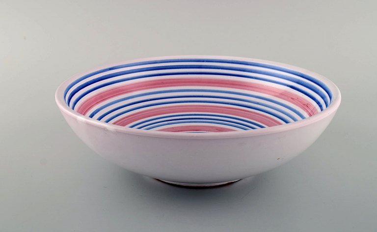 Ingrid Atterberg for Uppsala Ekeby. Large bowl in glazed stoneware. Striped design in blue and pink shades. Dated 1951-52.