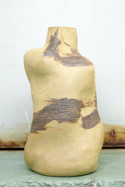 Christina Muff, Danish contemporary ceramicist (b. 1971). Bottleshaped sculptural vase in golden stoneware clay with slip fromFrederiksberg in Copenhagen. The vase is glazed inside with clear shiny glaze. The slip is painted on the outside.