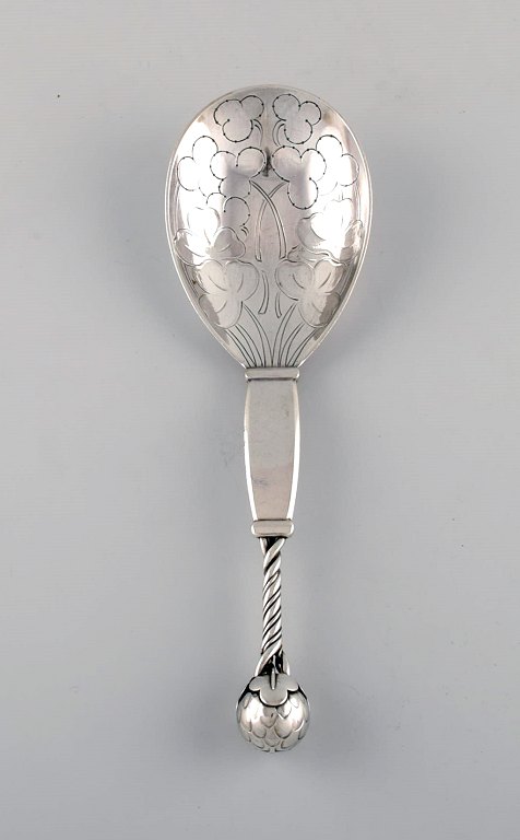 Rare Georg Jensen strawberry spoon in sterling silver designed with openwork head and partially twisted handle, knob made with stylized foliage and strawberries, dess. 35.