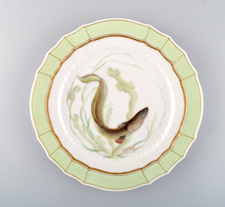 Royal Copenhagen fish plate with green edge, gold decoration and fish motif. Model 919/1710.