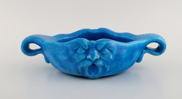 Edmond Lachenal (1855-1948), France. Unique art nouveau bowl with handles in glazed ceramics with a motif of grotesque. Beautiful turquoise glaze. Dated 1910-1920.