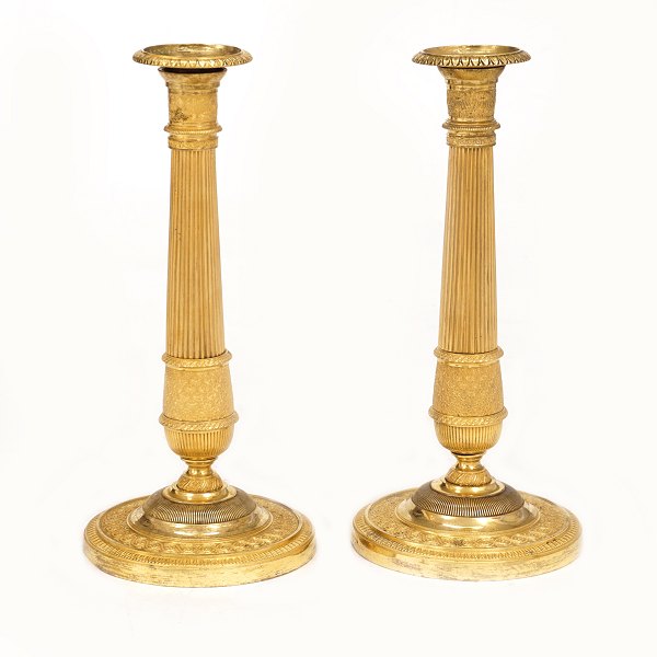 A pair of firegilt candlesticks. France circa 1810-20. H: 27cm