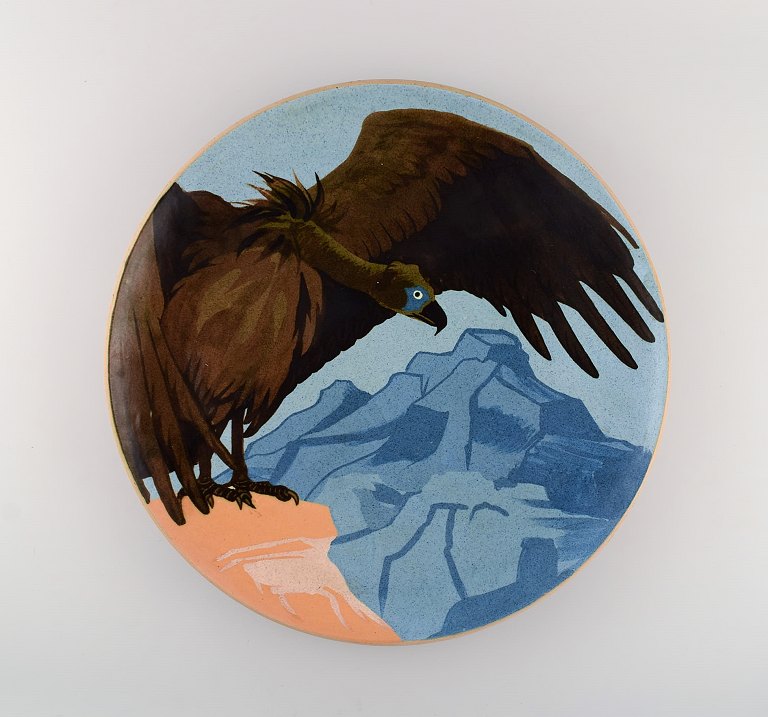 Karl Hansen Reistrup (1863-1929) for Kähler. Colossal unique dish in glazed ceramics. Vulture and mountain landscape. Museum quality. Approx. 1900.