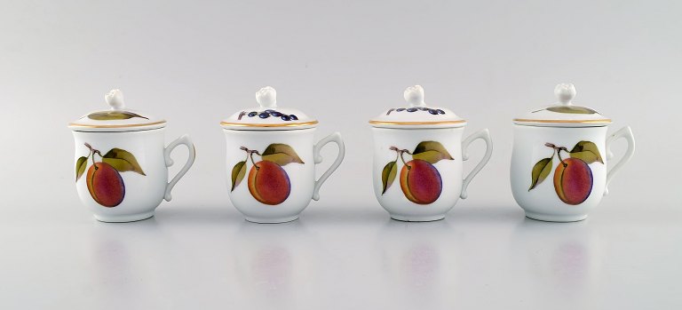 Royal Worcester, England. Four Evesham porcelain cream cups decorated with fruits and gold edge. 1960s.
