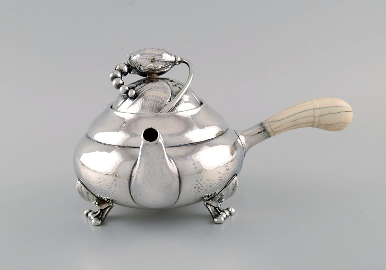 Georg Jensen Blossom teapot in hammered sterling silver with ivory handle. Model 2C. Dated 1915-1930.