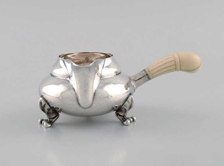 Georg Jensen Blossom creamer in hammered sterling silver with ivory handle. Model 2C. Dated 1915-1930.