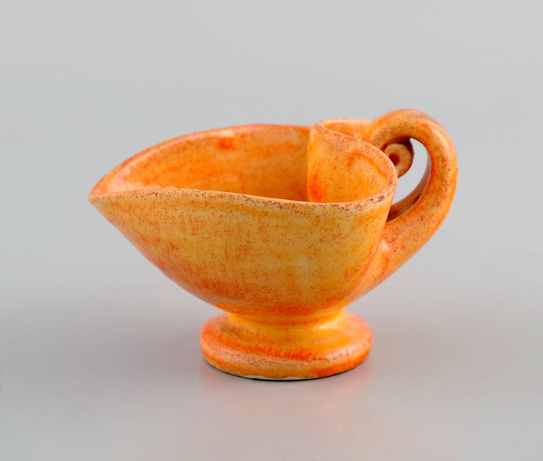 Kähler, Denmark. Cream jug in glazed stoneware. Beautiful orange uranium glaze. 1940s.