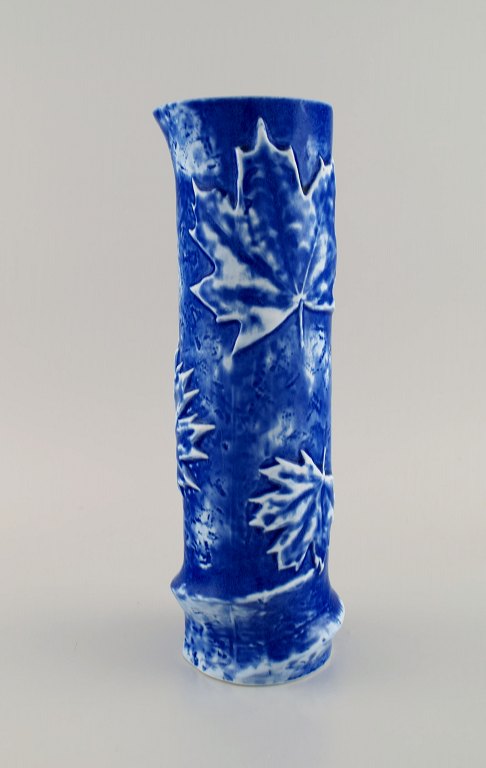 European studio ceramicist. Cylindrical vase in glazed ceramic decorated with maple leaves. Beautiful glaze in shades of blue. Late 20th century.