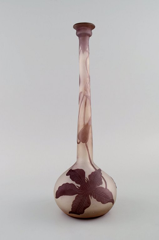 Narrow neck Emile Gallé vase in frosted and purple art glass carved in the form of foliage. Early 20th century.
