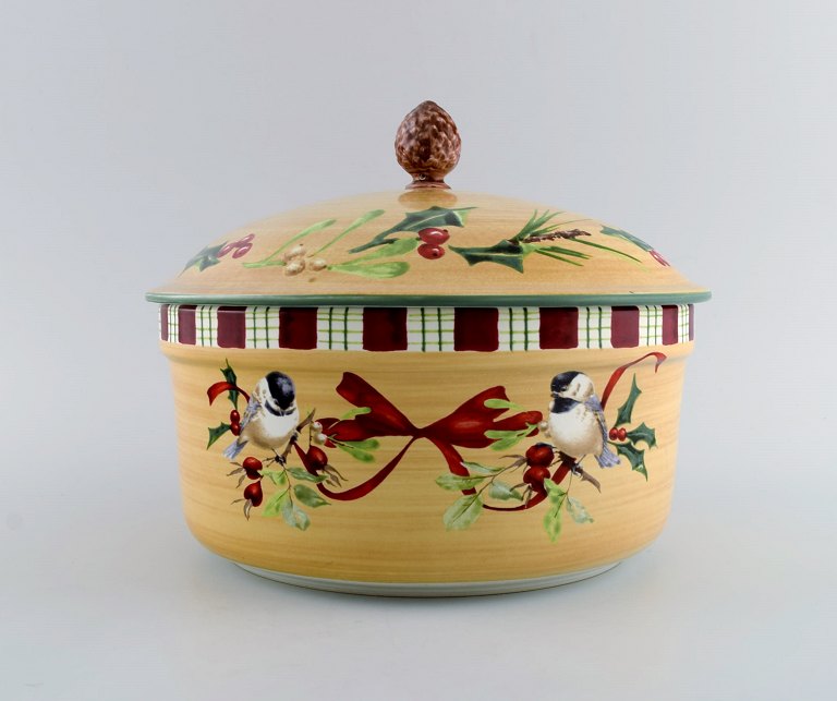 Catherine McClung for Lenox. "Winter greetings everyday". Large lidded tureen in glazed stoneware decorated with mistletoe, birds and red ribbon. Lid knob modeled as a fir cone. Approx. 2000.