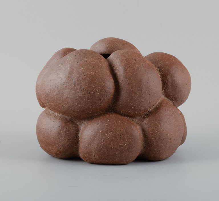 Christina Muff, dansk samtidskeramiker (f. 1971).Golden brown unglazed stoneware clay vessel with specks. Organically shaped. Clear glaze inside.