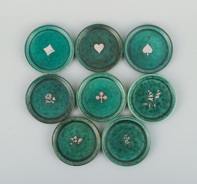 Wilhelm Kåge gets Gustavsberg.A set of eight "Argenta" bottle trays.