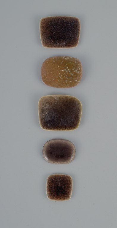 Ole Bjørn Krüger (1922-2007), Danish sculptor and ceramicist.Five unique brooches in glazed stoneware in shades of brown.