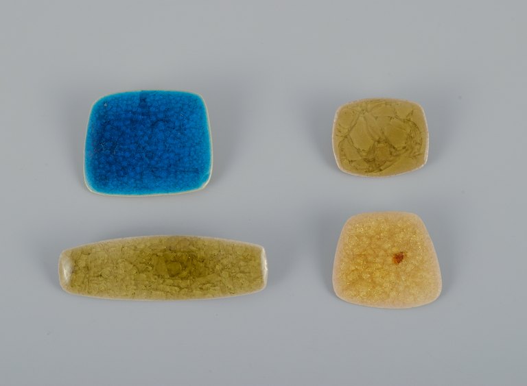 Ole Bjørn Krüger (1922-2007), Danish sculptor and ceramicist.Four unique brooches in glazed stoneware in shades of blue and yellow.