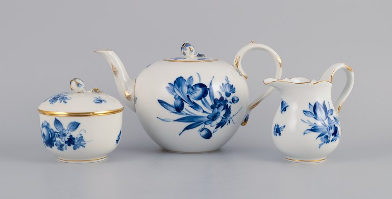 Meissen, Germany, teapot, creamer and sugar bowl.Hand painted in blue with flowers and insects. Gold decoration on rims.